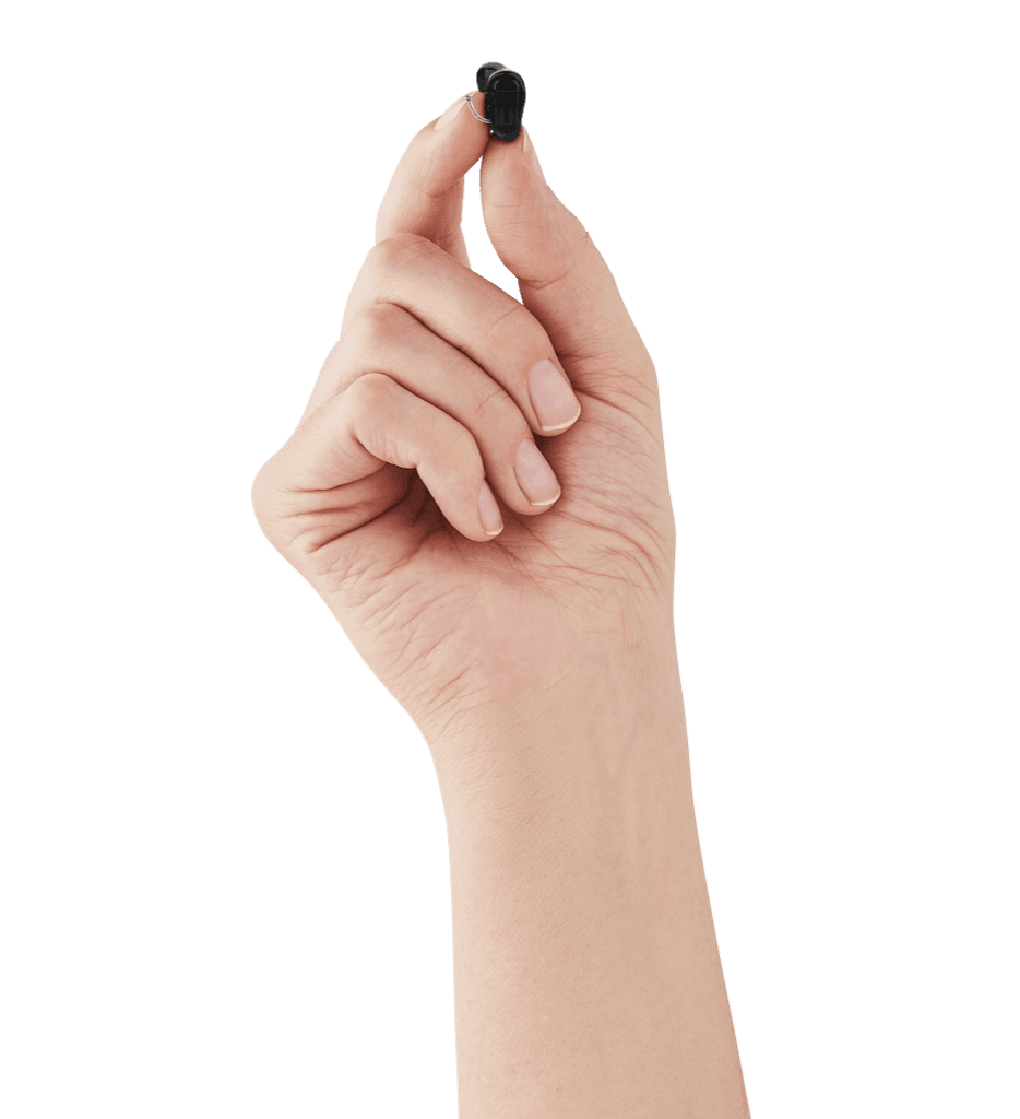 A completely-in-canal hearing aid held between two fingers