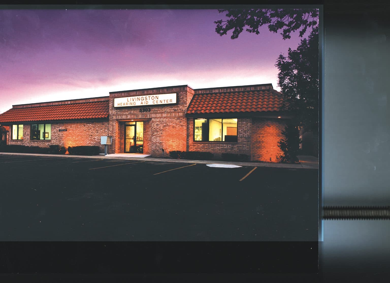 Livingston Hearing Aid Center building at dusk, 1990