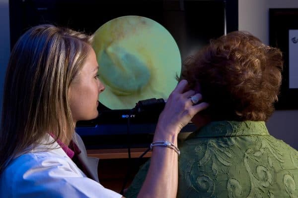 Audiologist using a video otoscope